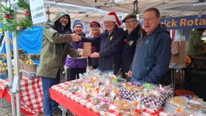 Local MP Marcus Campbell Savours presenting 'Best Stall' award to Keswick Rotary